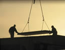 lifting heavy beam at dawn